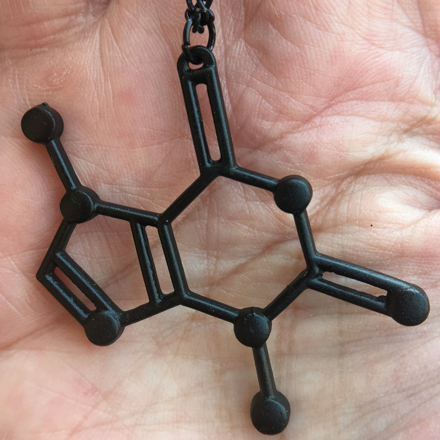 Dije molécula chocolate con cadena - NALANDA | Tu motor de búsqueda interna